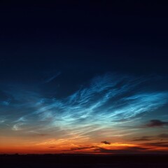 Obraz premium Stunning electric blue noctilucent clouds glowing in night sky.