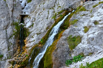 Waterfall flowing down rocks in Tamar, Slovenia