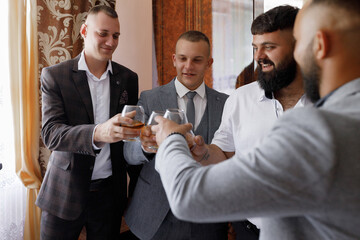 Friends celebrating with drinks at a gathering in a cozy indoor setting