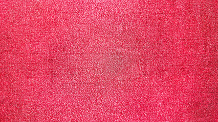 Fototapeta premium Vibrant red fabric texture background with soft woven pattern, ideal for abstract design, textile themes, wallpapers, and creative Christmas graphic projects.