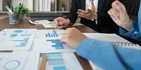 Strategic Business Discussion. Team members analyzing data and presenting ideas in a collaborative office.