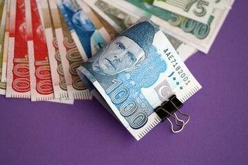 Pakistan rupees banknotes on purple background. The current Pakistan money bills