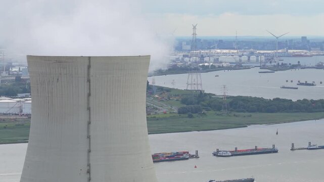 Drone aerial of Doel Nuclear Power towers releasing vapor into sky, Belgium