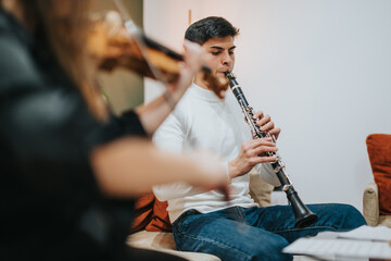 Fototapeta premium Musical performance featuring a clarinet and violin with cozy and expressive ambiance indoors.