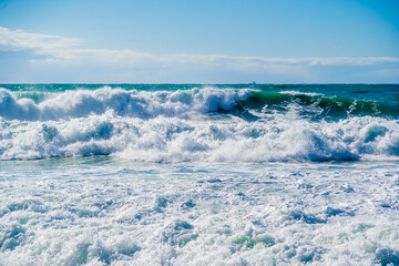 Kabardinka resort. Black sea. Large emerald-colored storm waves roll towards shore. Lots of squirts and foam