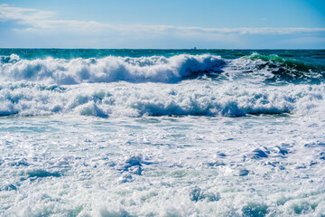 Kabardinka resort. Black sea. Large emerald-colored storm waves roll towards shore. Lots of squirts and foam