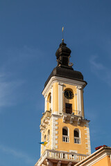Historic clock tower with intricate architectural details against a clear blue sky, showcasing the beauty of travel destinations and cultural heritage. Kamianets-Podilskyi, Ukraine