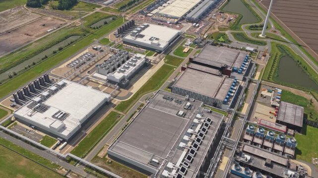 Aerial drone of data center with cooling towers, cloud computing hub exterior