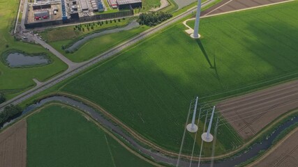 Drone panorama of modern data centers beside wind turbines in Holland - Powered by Adobe