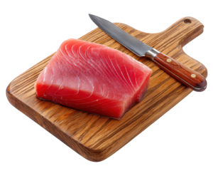 Fresh raw tuna steak on wooden chopping board with sharp kitchen knife, vibrant red color, healthy seafood ingredient for sushi or sashimi, isolated on transparency background