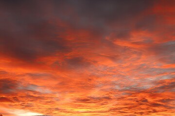 Dramatic sunset sky with vibrant orange and gray clouds