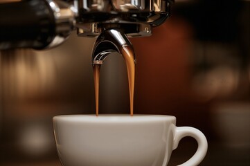 Fototapeta premium Close-up of Espresso Being Poured into a White Cup