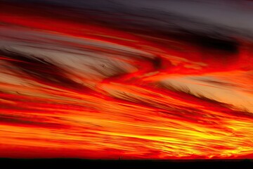 Fiery sunset clouds streaking across a dramatic sky