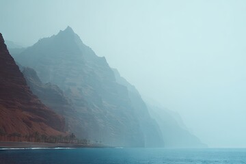 Misty coastal mountains meet the sea