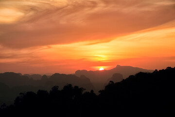 Stunning sunset above tropical forest and karst formation valley