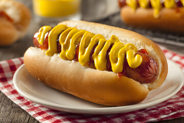 Juicy hot dog with golden ustard swirls, a carnival east, evokes National Hot og Day and quirky Americanpicnics