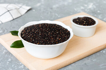 quinoa seeds in bowl on colored background. Healthy kinwa in small bowl. Healthy superfood