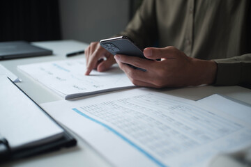 Businessman reading report in office desk analyse data for plan project
