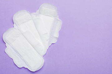Women hygiene products or sanitary pad on colored background. Pastel color. Closeup. Empty place for text. Female daily hygiene