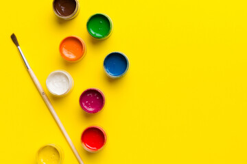 art palette with paint and brushes, close up. Top view with empty space. workplace for creativity. home teaching concept drawing