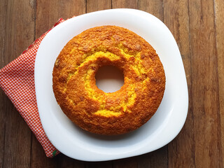 simple cornmeal and corn cake on a wooden background seen from above