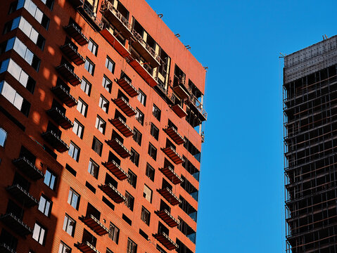 Two modern buildings under construction architecture backdrop