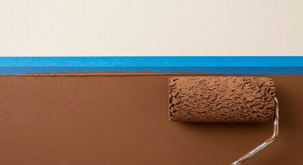 A paint roller with rich brown paint is shown in motion, creating a broad, even stripe on a white wall. The blue painter's tape on the wall ensures a precise and clean edge