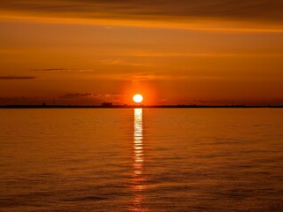 Fototapeta premium A Stunningly Beautiful Sunset Over a Peaceful Water Reflection Scene