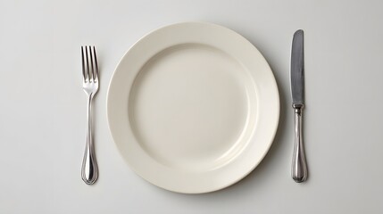 Empty white plate with fork and knife table setting minimal background