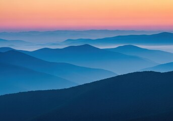 Obraz premium Serene mountain range landscape with misty atmosphere at colorful dawn