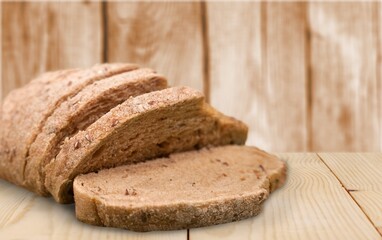 Freshly Baked tasty Crusty Bread Sliced on Board.