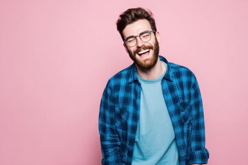 Fototapeta premium Happy smiling bearded man wearing glasses and casual clothing against pink background.