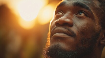 Close Up of Young Man Looking Thoughtfully Towards Bright Sunset Light in Nature.