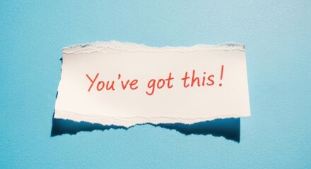 Inspiring message "You've got this!" ripped from a bright blue background