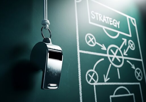 A silver whistle hangs in front of a chalkboard displaying a soccer strategy diagram with the word strategy at the top