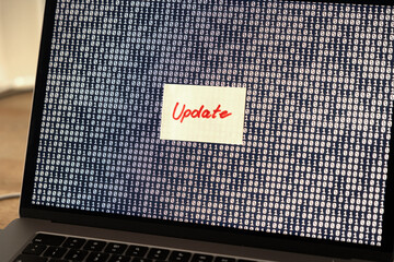 Computer software updates, note on the screen of a laptop. Technology, system update, new release, system configuration, computer language.