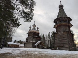 Historical Wooden Churches Surrounded by Snowy Landscape