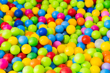 A sea of colorful plastic balls fills a childrens play area inviting kids to jump in and enjoy the vibrant atmosphere Sunlight enhances the playful setting creating joy