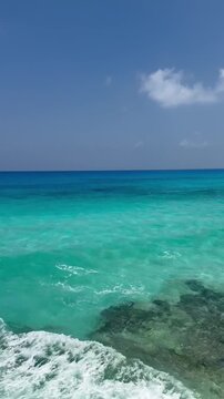 Real-time footage of waves splashing on coastline rocks. Mediterranean sea near El Alamein city, North Coast, Marsa Matrouh governorate, Egypt
