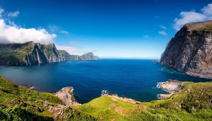 a majestic atlantic ocean fjord unfolds framed by towering cliffs and lush greenery the deep blue waters contrast with the vibrant hues of the surrounding landscape creating a breathtaking panorama