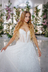 A bride in a hall decorated with flowers, decorated with flowers