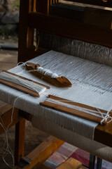 Traditional wooden weaving loom with shuttle and threads – textile craft photo
