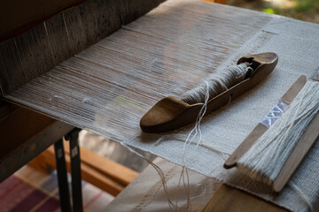 Traditional wooden weaving loom with shuttle and threads –textile craft photo