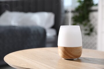 One stylish aroma lamp on wooden table indoors, closeup. Space for text