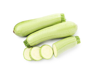 Fresh whole and cut zucchinis isolated on white, top view
