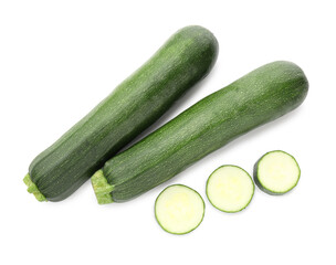 Whole and cut fresh zucchinis isolated on white, top view