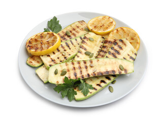 Delicious grilled courgette slices with pumpkin seeds, lemon and parsley isolated on white
