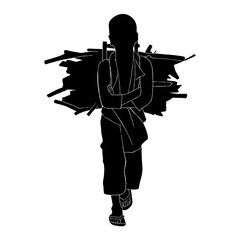 The black shadow of a boy walking along the path, gathering firewood.
