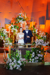 The bride and groom listen to congratulations and toasts from guests