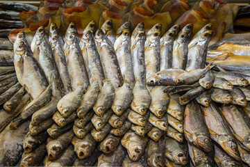 Many dried and smoked fish at local market, for culinary ingredient and snack concept. Traditional seafood.